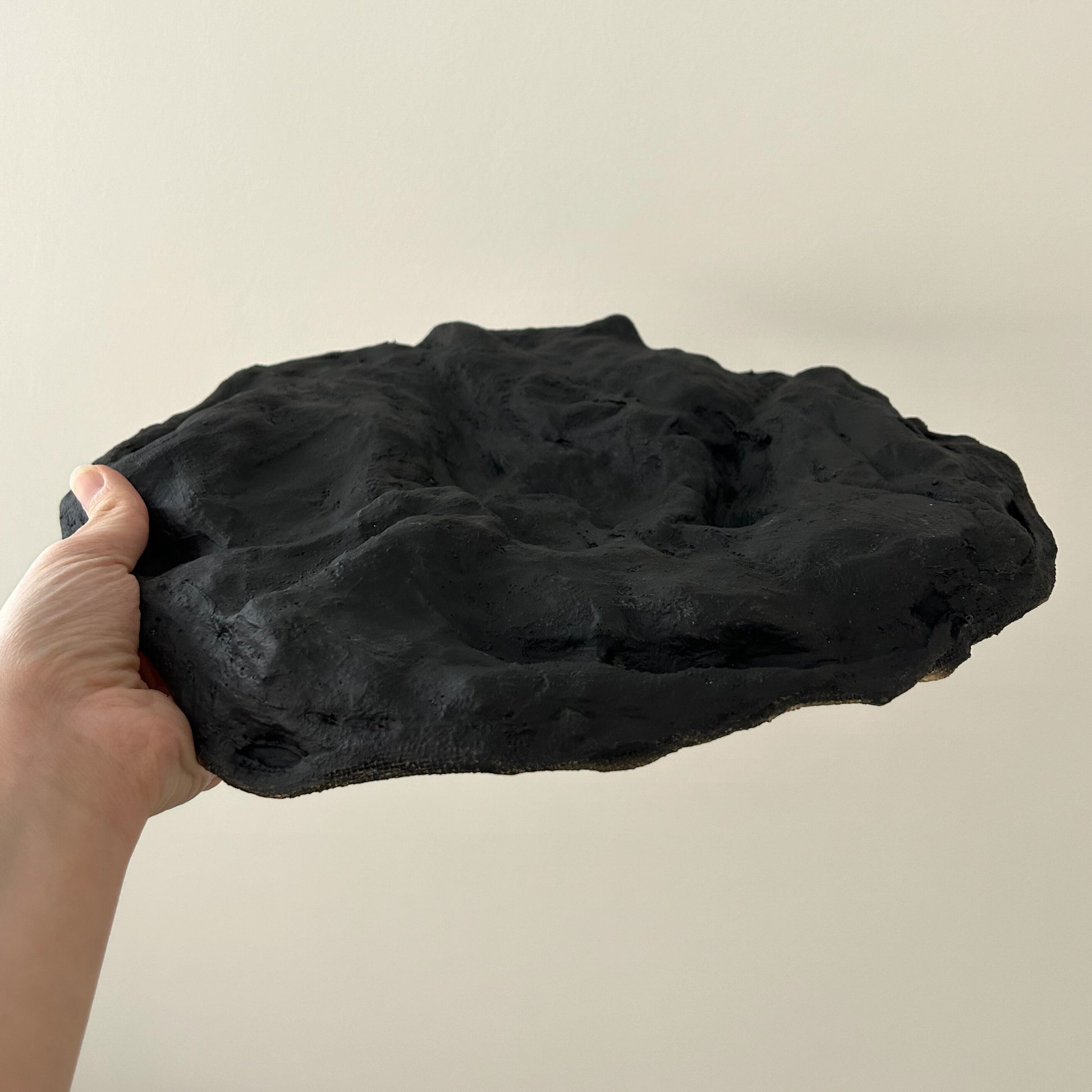 Bottom view of the tray showing its matte black textured base