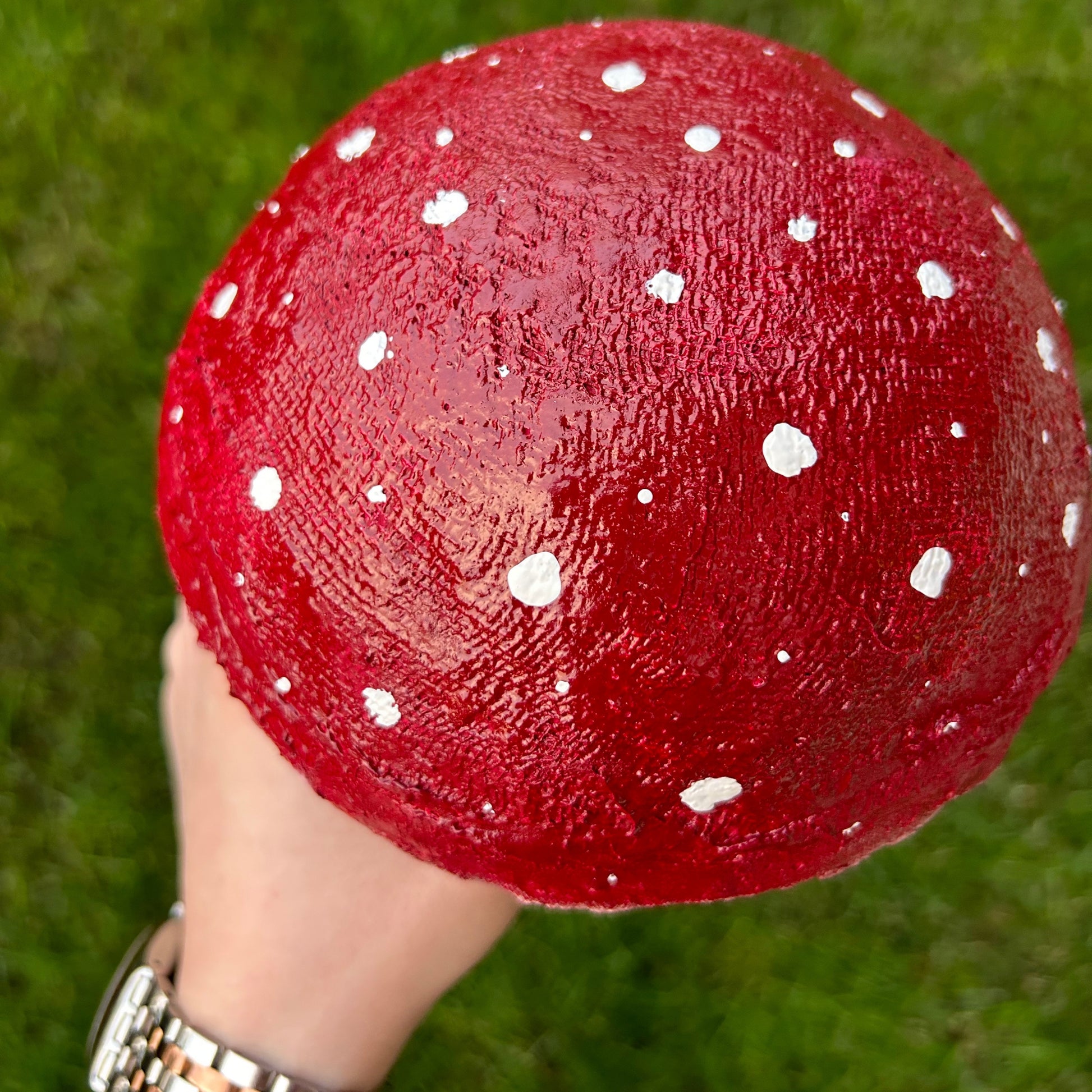  Detailed look at the red cap with white dots of the whimsical mushroom decor