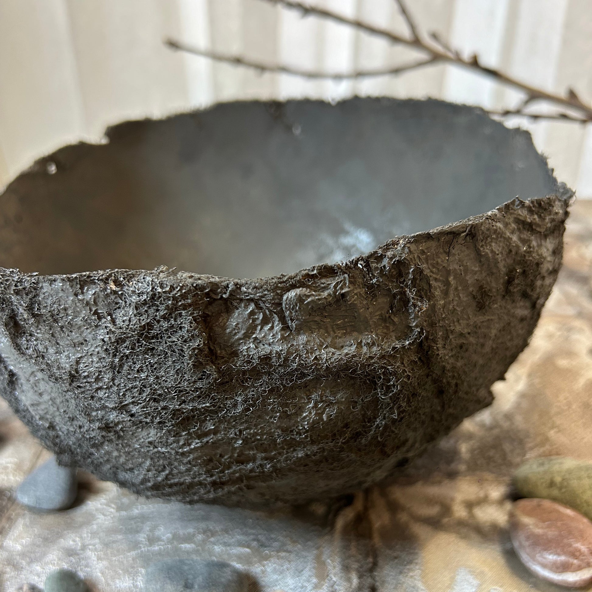  Side angle of organic handmade bowl showing raw textured surface.